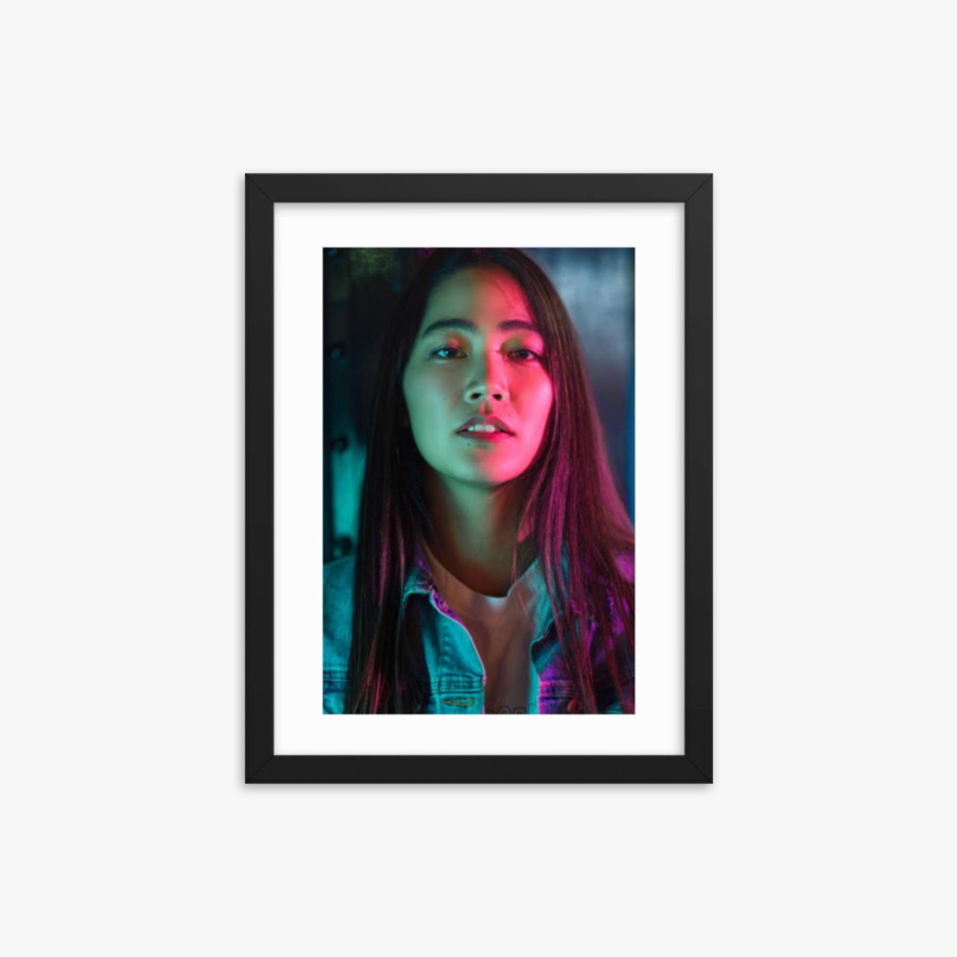 Portrait of young woman lit by colorful neon lights at night 12x16 in Poster With Black Frame